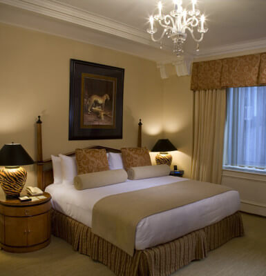 Interior Suite #814 is decorated in warm browns and beiges beneath a lovely chandelier.