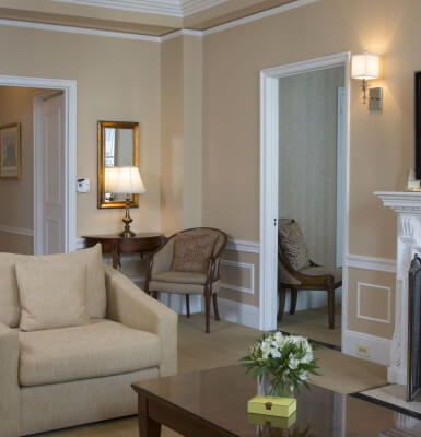 Beautiful architectural details and a grand fireplace define the living area in Suite #1609.