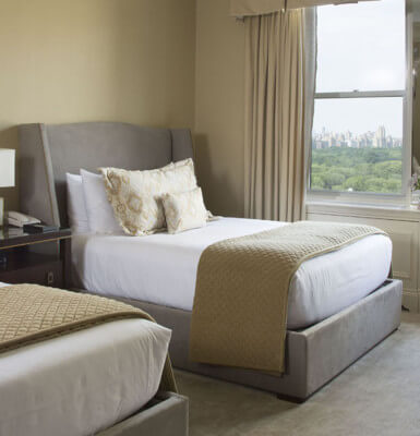 Room #2113 features two double beds with a view of the city.