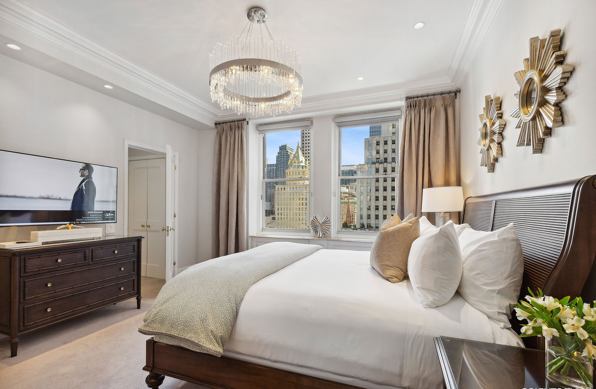 Refined bedroom with large windows, city views, and modern classic furnishings